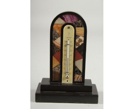 A DERBYSHIR ASHFORD THERMOMETER with coloured specimen marbles, black frame and thermometer. 5.75ins long.