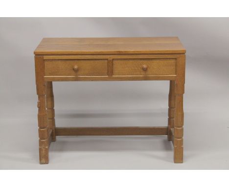 ROBERT "MOUSEMAN" THOMPSON. AN OAK SIDE TABLE with an adzed rectangular top, two frieze drawers with turned knob handles on f