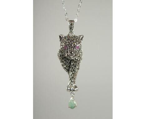 A SILVER RUBY, EMERALD, MARCASITE PANTHER PENDANT AND CHAIN.