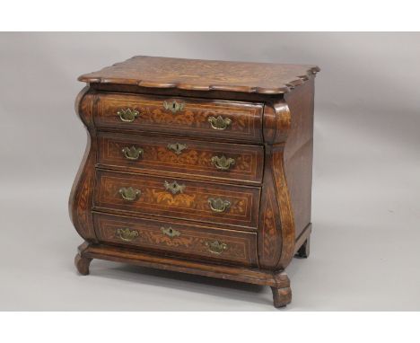 AN 18TH CENTURY, DUTCH MARQUETRY, SHAPED FRONT COMMODE with four long shaped graduated drawers with brass handles, supported 