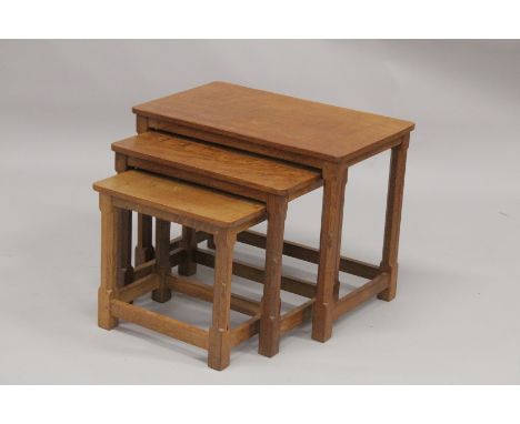 ROBERT "MOUSEMAN" THOMPSON. AN OAK NEST OF THREE TABLES, each with an adzed rectangular top, on four champered square legs. L