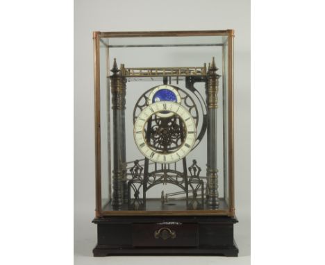 A LARGE MOONPHASE CONGREAVE CLOCK in a glass case.