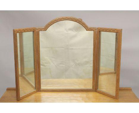 ROBERT "MOUSEMAN" THOMPSON. AN OAK  TRIPLE PANEL FOLDING DRESSING TABLE MIRROR with arched central mirror, flanked by a pair 