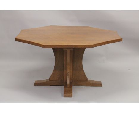 ROBERT "MOUSEMAN" THOMPSON. AN OAK  OCTANGONAL DINING TABLE with a adzed concave sided top, supported on a solid X shape colu