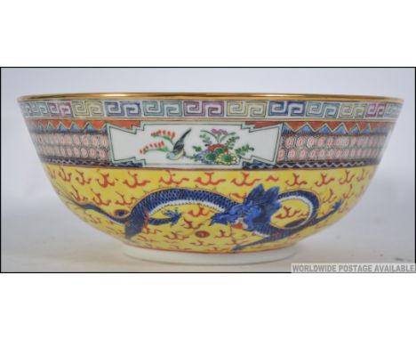 A Chinese famille  / juane rose bowl with decorative yellow panel work, green and blue dragons and geometric panel work elsew