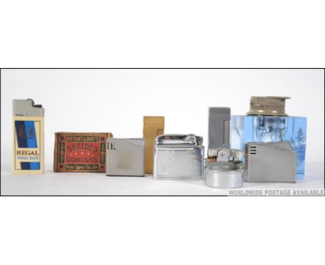 A  collection of lighters to include a Mosda Streamline, Calibri, Maruman, Dunhill,  Maruman Halley, blue glass table lighter