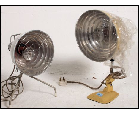 A vintage and a retro heat lamps by Pifco, both with pendant shades, the vintage lamp having a cast metal base and the retro 