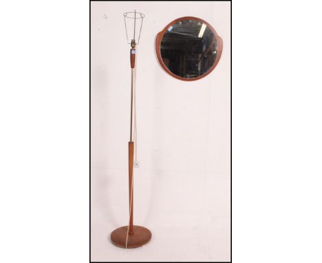 Mid century brass trimmed teak standard lamp along with a mirror , framed in unusual form in teak .  Measures: 49cm x 52cm.