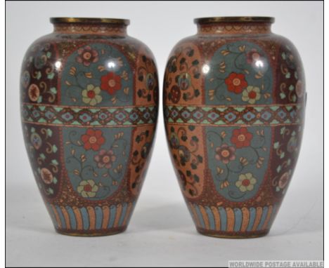 A pair of Chinese / Japanese brass and enamel vases each with stunning enamelled geometric and scrolling patterns. Measures: 