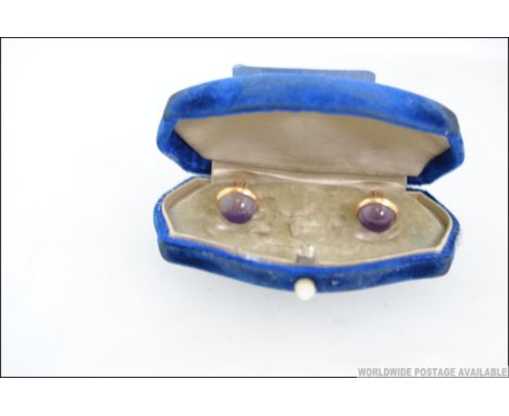 A stunning pair of 14ct gold early 20th century amethyst set gentlemans cufflinks. The cabochon polished amethysts to centre.