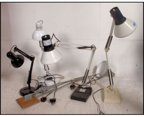 A group of retro vintage anglepoise lamps . 4 with stands ( 3 white , 1 black ), and 1 with wall bracket in grey .  5 lamps i