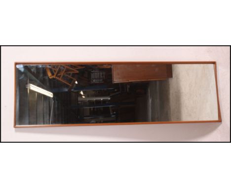 A large retro 20th century rectangular teak framed wall mirror, having a tapering teak frame with central mirror panel