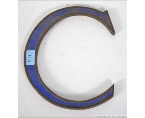 An early 20th century vintage metal exterior shop letter ' C ' with blue enamel centre 17cms wide