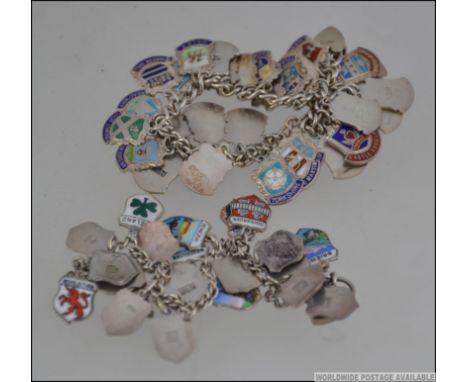 2 silver 800 marked charm bracelets each being adorned with silver and enamel charms showing coat of arms for towns/city's in