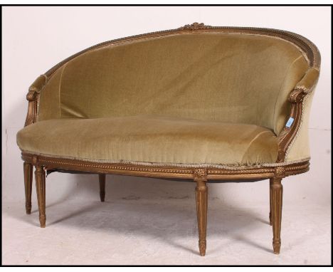 A 19th century Frech Canape sofa settee in giltwood. The turned legs supporting a rounded frame with green velour overstuffed