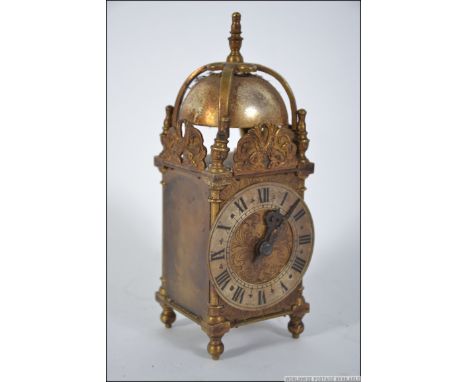 A mid 20th Century mantel timepiece carriage clock modelled in the form of a lantern clock by Davall, The brass case with str