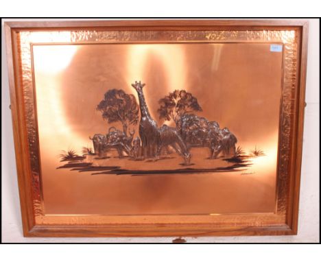 A retro 1970's copper wall panel mounted in a teak frame. The copper panel embossed into relief with diorama of African anima