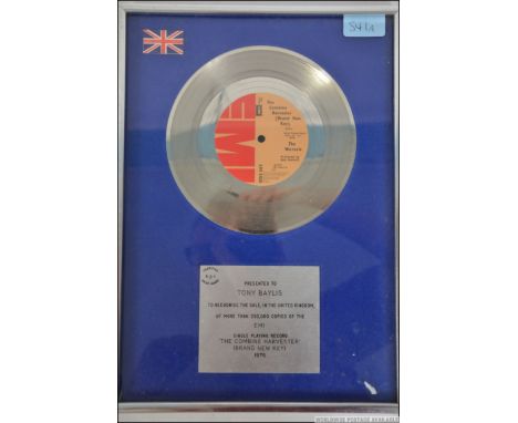 A framed, glazed and mounted Silver disc for The Wurzels ' The Combine Harvester '. Presented to Tony Bayliss ( Bass player )