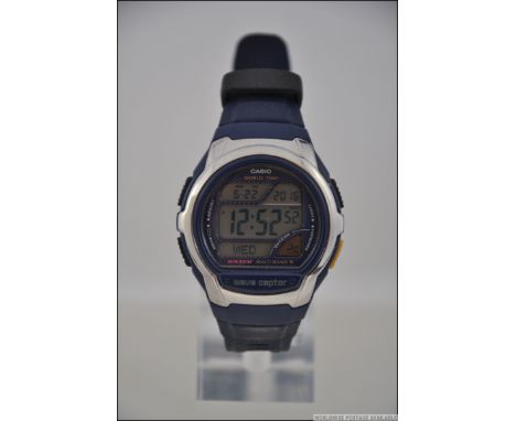 A Casio Watch model WV-58E Radio Controlled World Time Wave Captor Multi Band 5 digital watch on blue strap