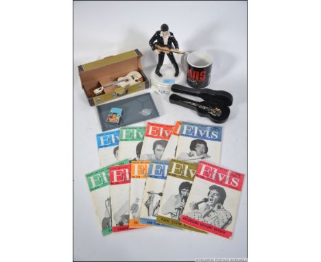 A collection of items all pertaining to Elvis Priestly to include ceramic figures, Elvis group watch, Lighter, Guitar display