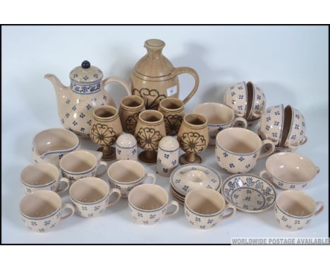 A large collection of blue and cream glazed tea service to include the teapot together with a collection of Mounter pottery.