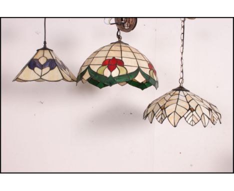 A collection of three Tiffany style pendant  leaded marbled and stained glass ceiling light shades of octagonal form
