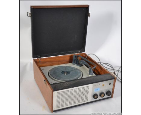 A retro  20th century four speed portable record player by Alba, having a lift up lid and carry handle to the side.