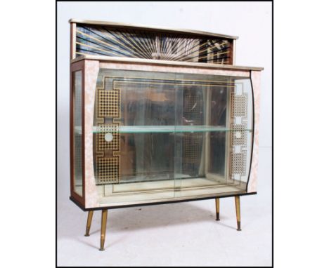 A 1950's retro cocktail display cabinet - china cabinet. The sliding glass doors with unusual design, above a stage gallery b