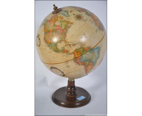 A vintage retro American globe of medium proportion along with a British vintage wall hanging barometer. Measures: 44cms high