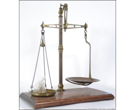 A large Victorian mahogany and brass set of scales by W & G Avery Ltd. Complete with some brass weights 66cms high