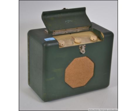 A 1950's early Roberts valve radio in the original green vinyl carry case retaining the original enamel Roberts badge