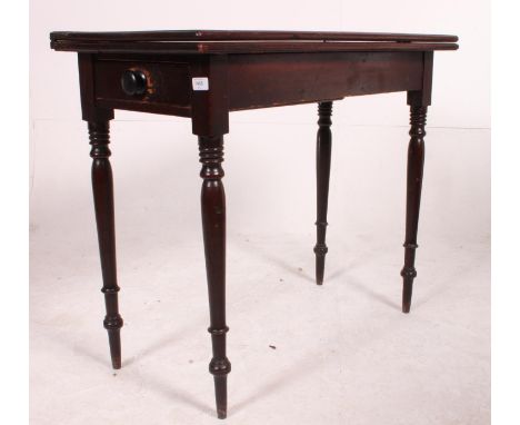 A 19th century mahogany card table / games table. The turned legs with fitted frieze having flip over table top above. Measur