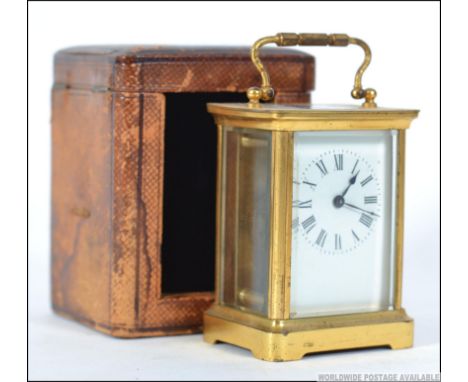 An early 20th century brass carriage clock complete with the original leather box with window front and key. The clock with s