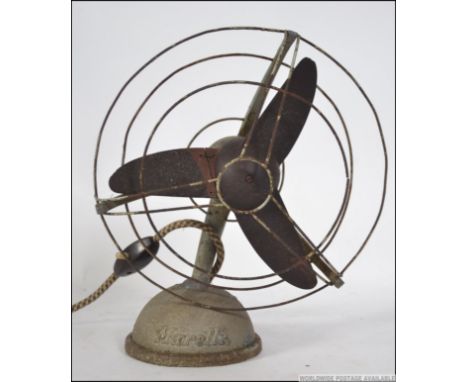 A vintage 1950's enamel painted metal desk top fan of Industrial design with original blades. 28cms high