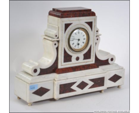 A large Victorian white marble and rouge marble mantle clock of classical form enclosing an enamel face with roman numeral ch