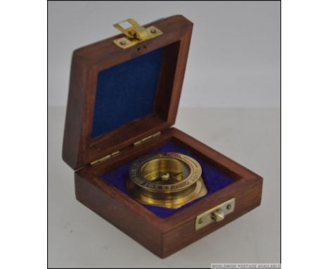 A 20th century brass cased military style compass, with glazed dial. 