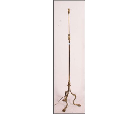 A 1900's Arts & Crafts brass telescopic standard lamp raised on splayed tripod leg base, square hammered column with extendin