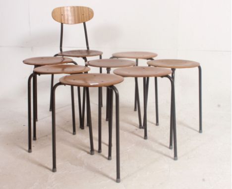 A collection of 8 rare  stacking stools in the manner of Arne Jacobson . The circular panel wood stool seats on tubular metal