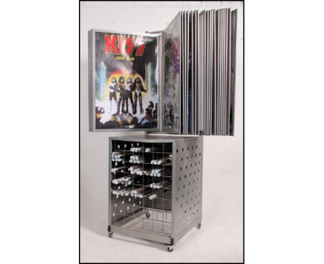 A retro Athena style enamel metal painted shop point of sale poster display unit and stand. Storage for rolled posters under 