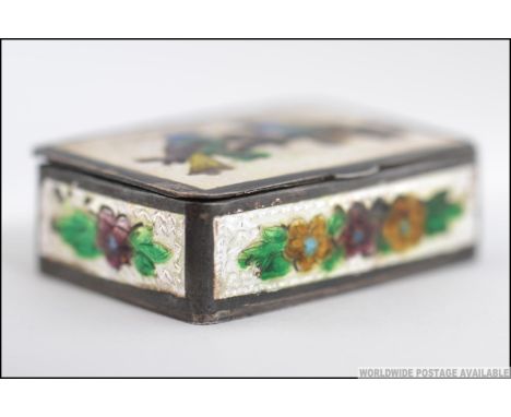 A silver and enamel set snuff box having enamel birds of paradise and floral sprays. weight 31.6g