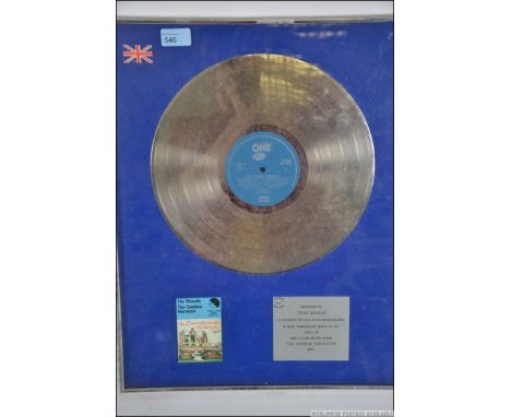 A framed, glazed and mounted Silver disc for The Wurzels ' The Combine Harvester '. Presented to Tony Bayliss ( Bass player )