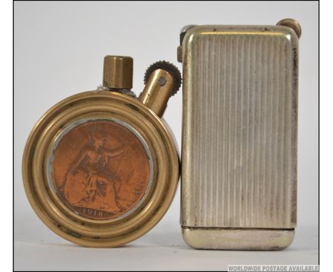 A WW1 trench art brass lighter with inset penny coin dated to 1918 together with a Quercia Flaminaire Carillon lighter in sil