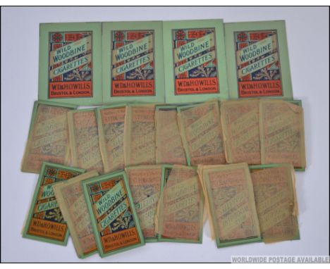 A collection of vintage cigarette dispenser advertising plates in metal with original paintwork for Wild Woodbine by WD&H Wil