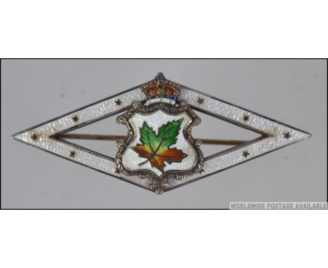 A large sterling silver Canadian WW1 diamond lozenge sweetheart brooch decorated with enamel guilloche with central maple lea