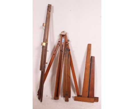 A collection of vintage wooden tripods - ideal for Strand theatre lighting - cinema lights together with vintage wooden measu