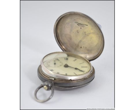 A silver 935 marked full hunter pocket watch with enamel dial and subsiduary seconds dial with inset key wound movement. Tota