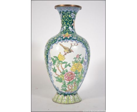 A detailed 20th century cloisonne enamel on metal vase. Depicting birds to central panel and foliates surrounding.  Measures: