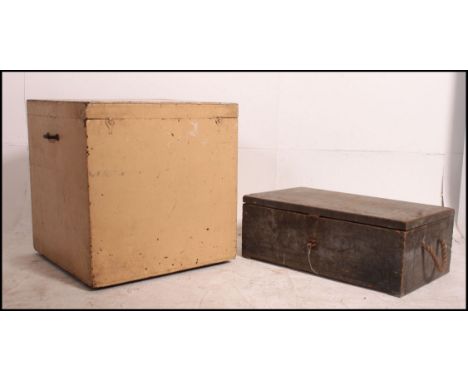 A 20th century painted pine shabby chic trunk chest with hinged top together with another having rope carry handles. Measures