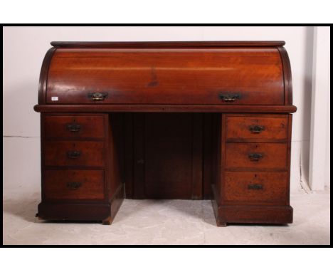 A mid Victorian large mahogany twin pedestal cylinder desk - bureau. Raised on plinth based pedestals each with a series of d