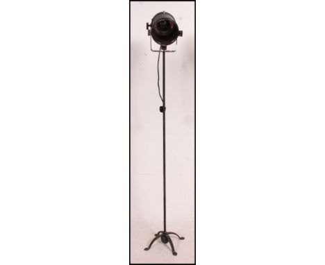 A vintage Industrial theatre / cinema light on an unrelated cast iron  tripod stand base of tall form.. Measures(cm) Height 1
